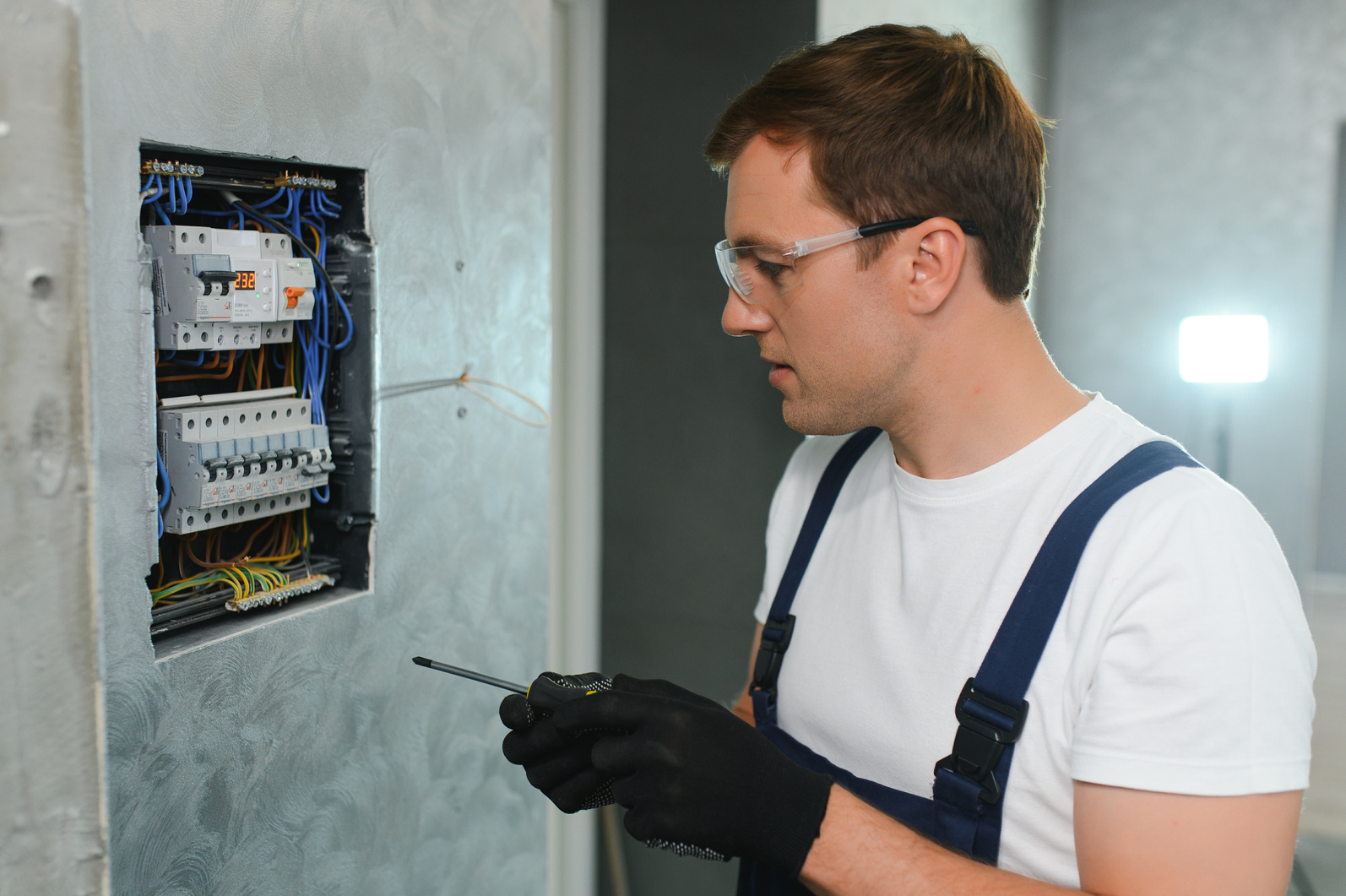 Electrician worker at work on an electrical panel